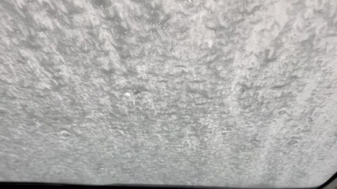 Car windshield covered in soap suds inside automatic car wash Stock Footage 340527247