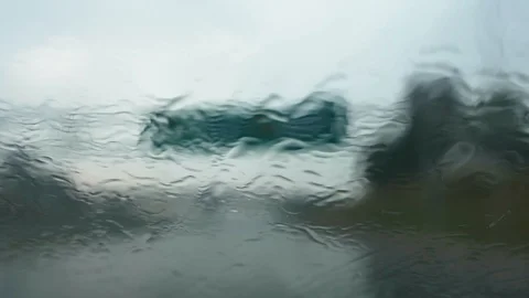 Car Windshield During Driving in Heavy Rain with Wipers Turned On Stock Footage 114687037