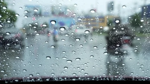 Car windshield with rain drops during heavy traffic downtown Stock Footage 96992277