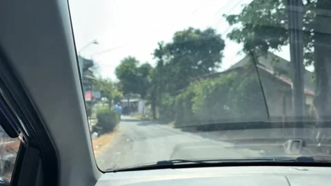 Car Windshield View Driving Down Village Road in Cirebon Stock Footage 346459899