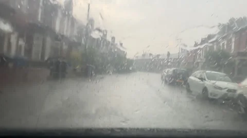 Car windshield view driving during storm in residential area. Stock Footage 301898460