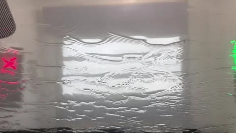 Car windshield view of water flowing during automatic car wash Stock Footage 340527331