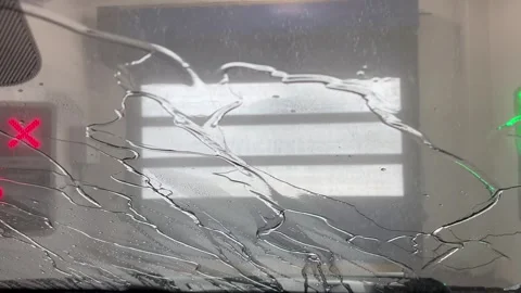 Car windshield view of water flowing down glass during car wash Stock Footage 340527355