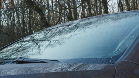 Car windshield washer spray and wipers cleaning wet front glass with sound Stock Footage 323413245