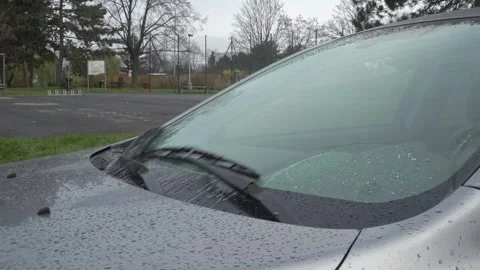 Car windshield washer system spraying water on glass during cleaning Stock Footage 331482935