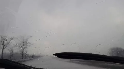 Car windshield wiper during rain on highway Stock Footage 281463538