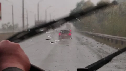 Car Windshield Wipers Clearing Heavy Rain from Glass POV Stock Footage 319585439