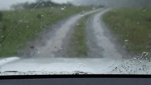 Car windshield wipers clearing raindrops Stock Footage 341502945
