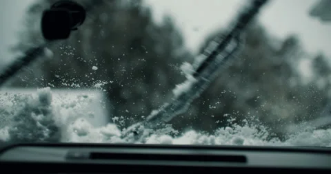 Car Windshield Wipers Clearing Snow off Glass with Brush Blades. Vehicle Stock-Footage 237417732