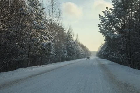 Car at the winter forest highway Stock Photos