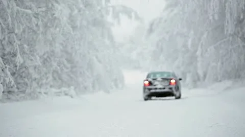Car on winter road reversing to camera Stock Footage 19892685