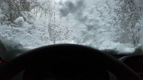 Car wiper blades clean the first snow from the car windshield n winter. inside Stock-Footage 144750604