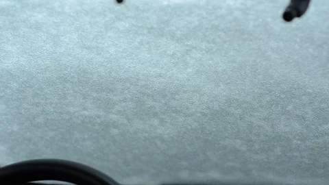 Car wiper blades clean windshield from snow in winter Stockbeeldmateriaal 123402440