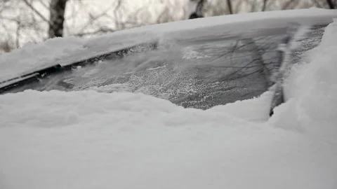 Car wiper blades clean the windshield from snow in winter Stock-Footage 261426593