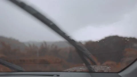 The car wipers are operating automatically in stormy weather conditions, and Stock Footage 154652210