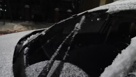 Car wipers cleaning the windshield from snow during a snowfall Stock Footage 261154212