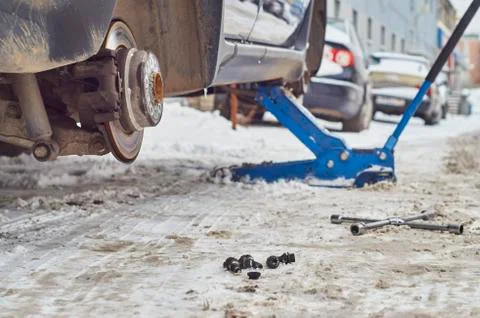 A car without the wheels on a jack Stock Photos