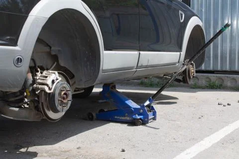 Car without wheels on the jack Stock Photos