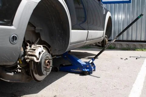 Car without wheels on the jack Stock Photos