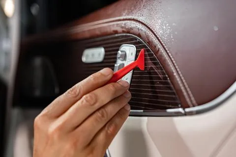 Car wrapping process, close up of man putting interior car protective film on Stock Photos