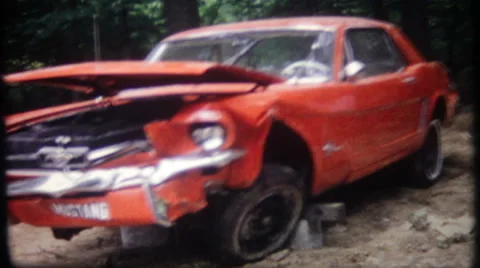 Car wreckage of classic 1965 Ford Mustang 1960s vintage film home movie 2965 Stock Footage