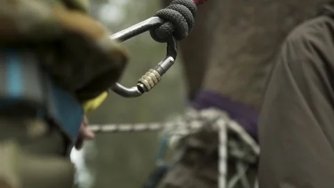 Carabiner being attached to harness Stock Footage 77013553
