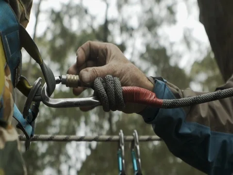 Carabiner being attached to harness Stock Footage 77013693