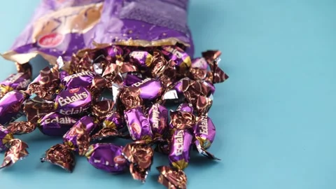 Caramel candy and packet on table Stock Footage 187708173