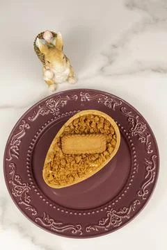 Caramel chocolate Easter egg with puff pastry and French vanilla cream fill.. Stock Photos