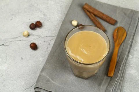 Caramel chocolate pudding on a gray table with chocolate and nuts. Stock Photos