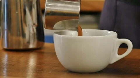 Caramel-colored liquid streaming down Stock Footage