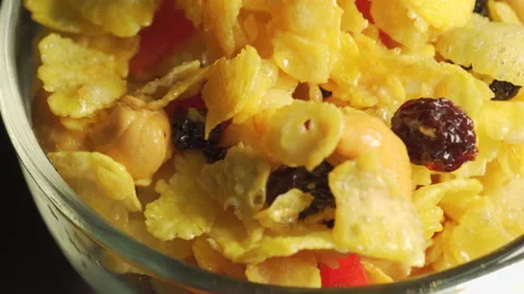 Caramel cornflakes with currant, cherry and cashew nuts. Breakfast menu  Video stock 143643900