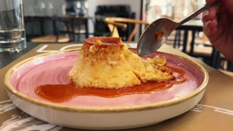 Caramel custard dessert. Serving a delicious homemade egg flan dessert. Stock Footage 297578035