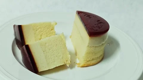 Caramel custard pudding cake halves and slices arranged on a plate. Stock Footage 345339641