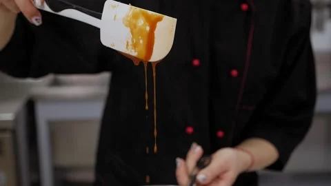 Caramel drips from the spoon. The process of preparing caramel in the kitchen. Stock Footage 136834224