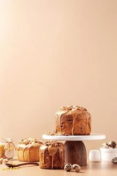 Caramel glazed Easter cakes decorated with nuts on pastel background. Easter Foto stock