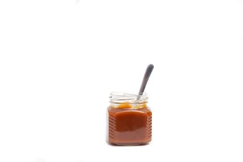 Caramel in a jar on a white background Stock Photos