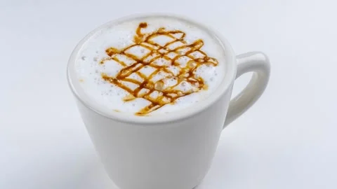 Caramel macchiato with crisscross drizzle pattern in white cup Stock Footage 337352371