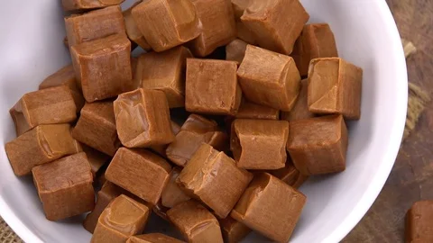 Caramel on a rotating wooden plate (seamless loopable; 4K) Stock Footage