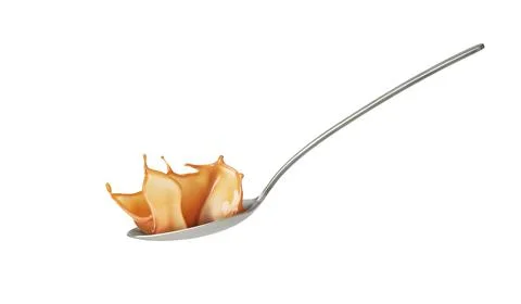 Caramel in a spoon on a white background Foto stock