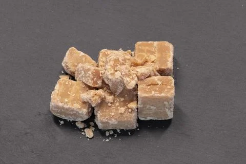 Caramel Tablet rest on dark surface Stock Photos
