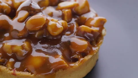 Caramel tart with nuts on a gray background Stock Footage 99252390