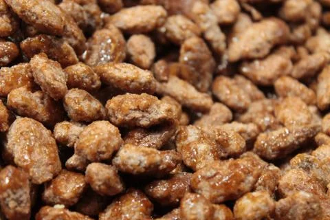 Caramelized almonds in the foreground Stock Photos