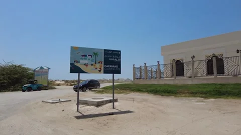Caravan Beach Camping Site - Palm Jebel Ali Sign in Dubai 動画素材 242864892