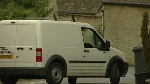 Caravan blocking traffic in narrow lane in English country village. Stock Footage 10582557