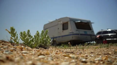 Caravan camper van on Beach. Parked trailer on Sand Stockbeeldmateriaal 312870634