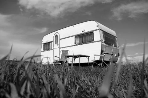 Caravan camping with table and two chairs Stock Photos