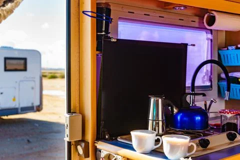 Caravan inside, preparing coffee in kitchen area Stock Photos