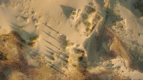Caravan of people with shadow on sand in the most bigger desert in Europe Stock Footage 151426853