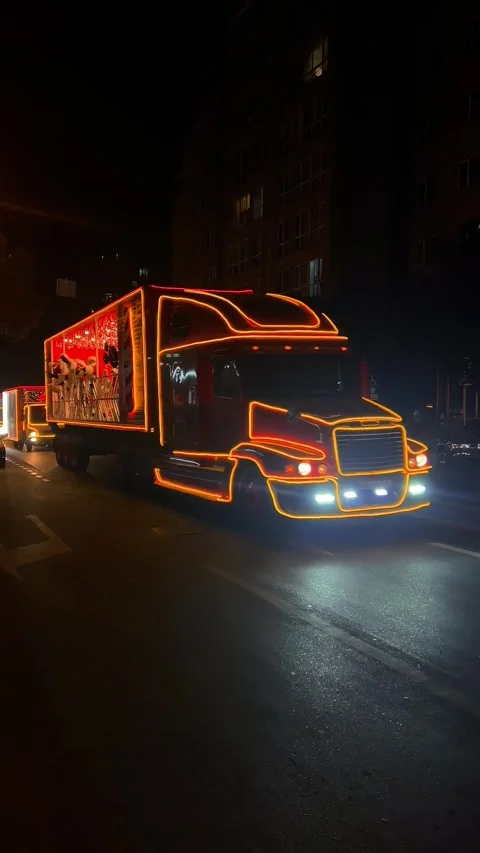 Caravan of red Coca-Cola trucks with lanterns at night. Stock Footage 259683268